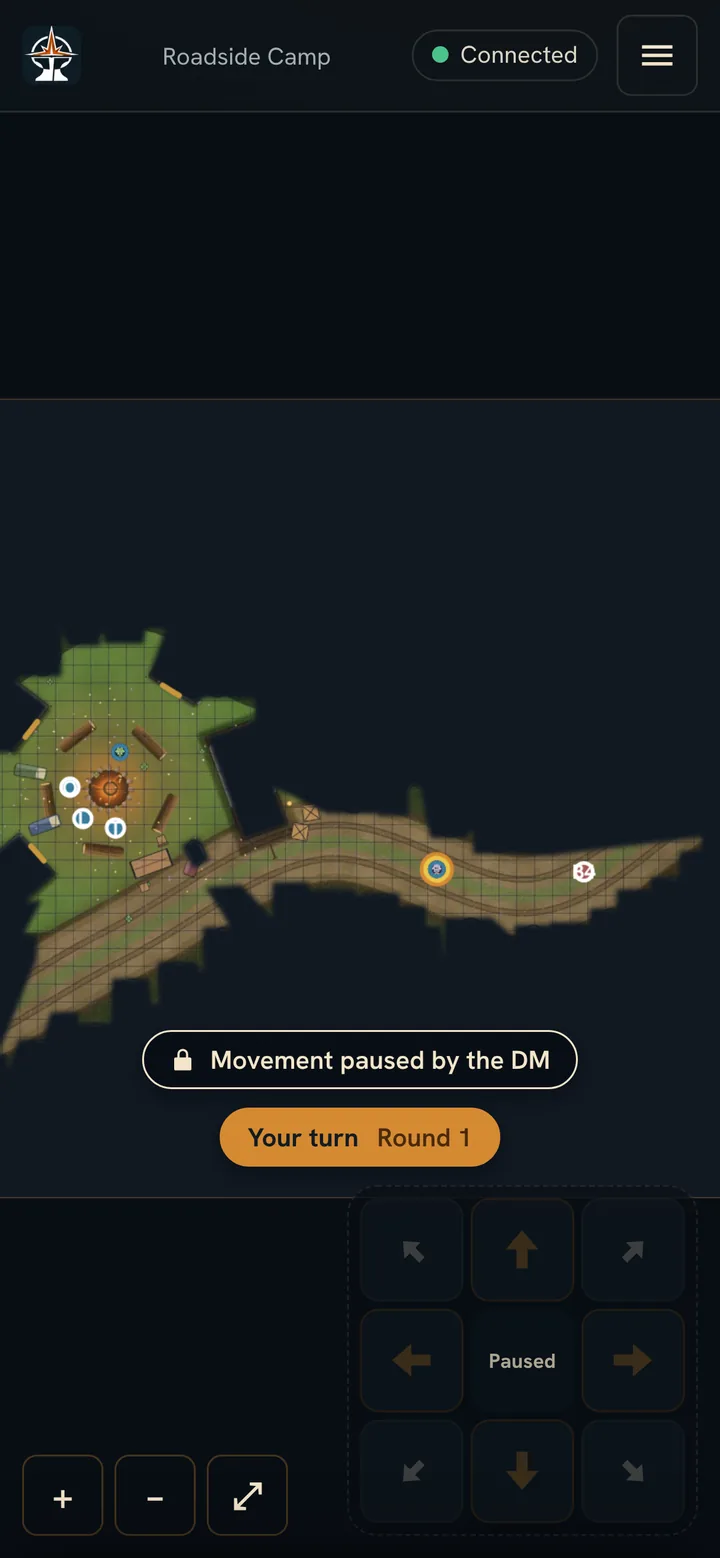 A player's phone on Roadside Camp while the DM has locked movement: a banner reads Movement paused by the DM and the move pad is greyed out and reads Paused.